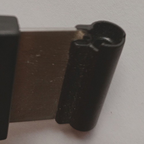 Black plastic cigar cutter used with metal cutting edges