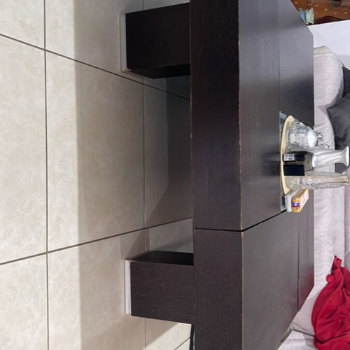 Coffee table made of solid wenge wood with storage and glass center
