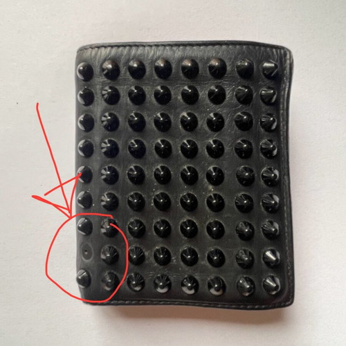 Christian Louboutin wallet used with missing spike and black stains