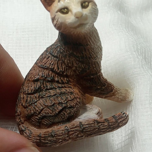 Cat miniature with realistic brown and white fur