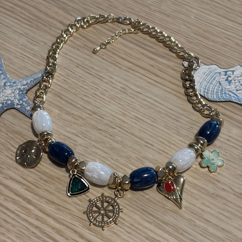 Statement necklace with blue and gold sea charms