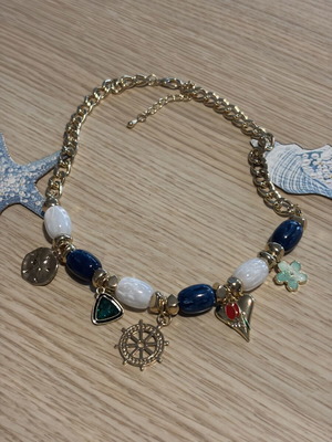 Statement necklace with blue and gold sea charms