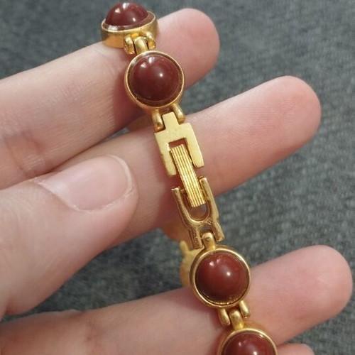 Vintage women's bracelet with red/brown cabochon beads on gold base, like new