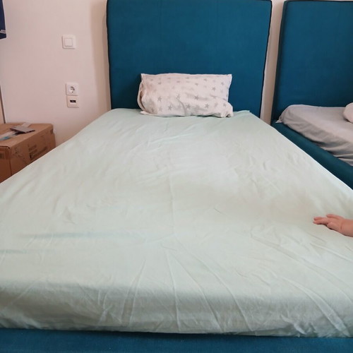 Single bed with teal fabric headboard and mattress, like new