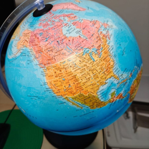 Illuminated world political map with Greek descriptions like new