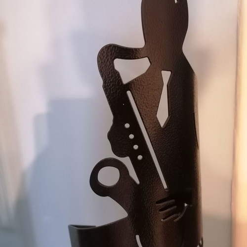 Metal CD holder like new with saxophone player design