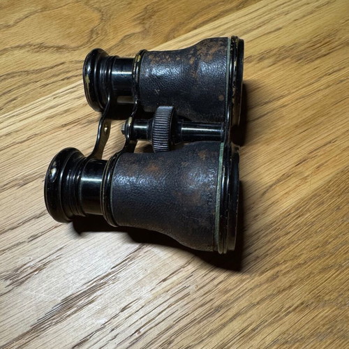 Vintage French binoculars used with leather covering good condition