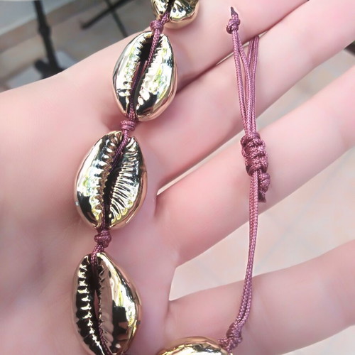 Handmade bracelet with gold metal shells and adjustable polyester cord