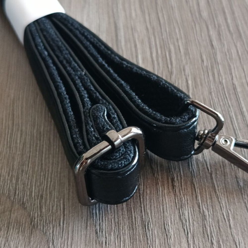 Handbag new with strap, black synthetic leather