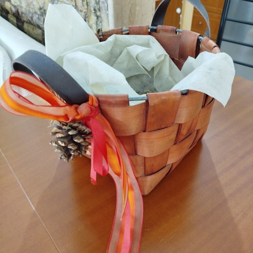 Wooden woven gift basket with leather handles, used