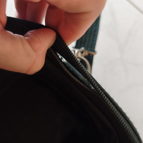 Toiletry bag used, green, fabric defect