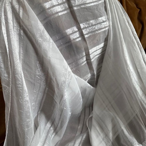 Large white table linen used with lace