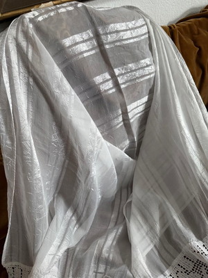 Large white table linen used with lace