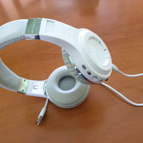 Bluetooth headphones used, white with MP3 and memory card options