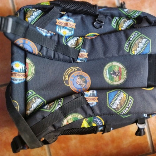 School backpack used with cut strap on the back