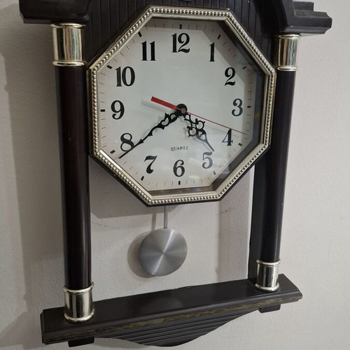 Quartz wall clock with pendulum used, faux wood plastic