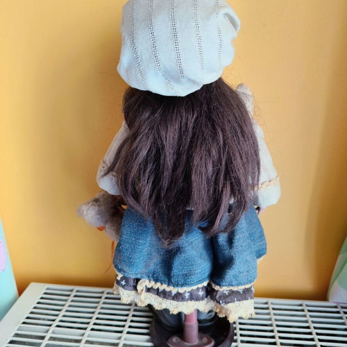 Porcelain doll with stand, 42 cm