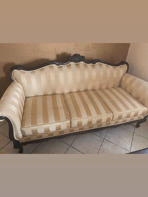 Vintage three-seater sofa with carved wooden frame