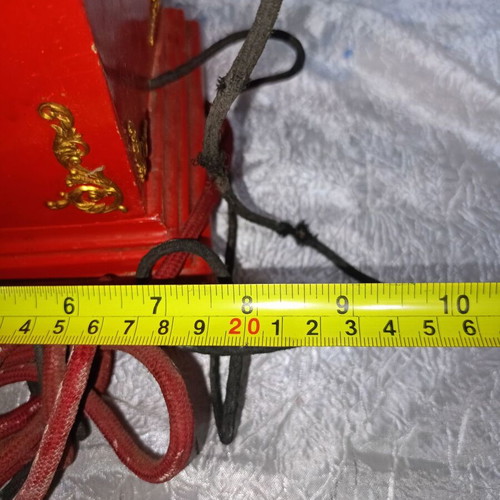 Vintage metal rotary phone, red with gold details