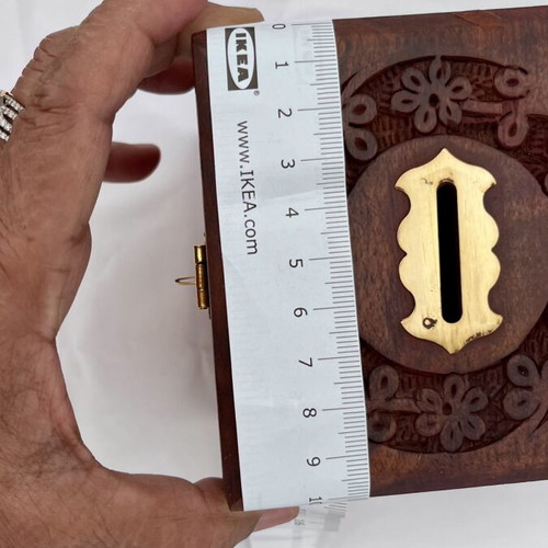 Wooden coin box with brass clip and carved design