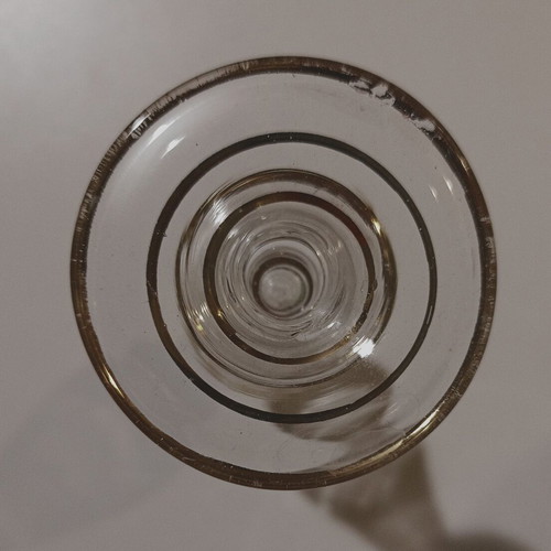 Glass perfume bottle used with golden accents and cap