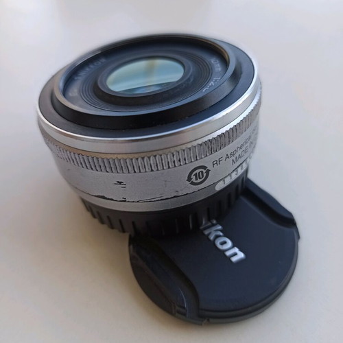 Nikon 1 NIKKOR 10mm f/2.8 lens used, silver compact prime