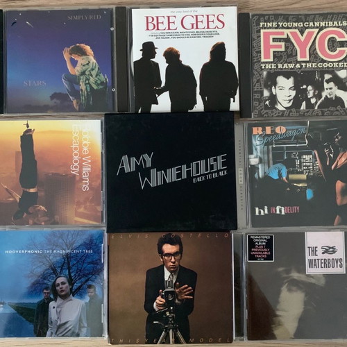 Collection of 9 used rock CDs including Robbie Williams and Amy Winehouse