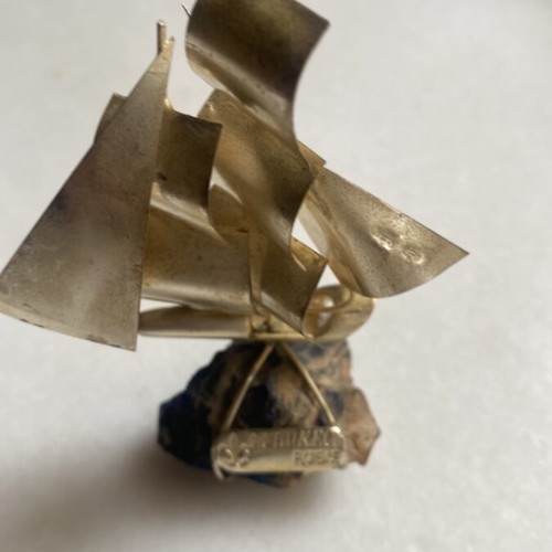 Metal small sailboat on semi-precious stone like new