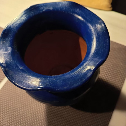 Handmade traditional clay vase with painted flowers