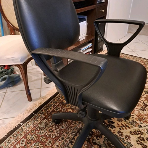 Office chair used with black leatherette upholstery