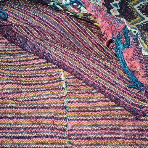 Old woven double horse saddle bag used with fabric tears