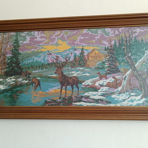 Handmade cross-stitch embroidery in wooden frame, used