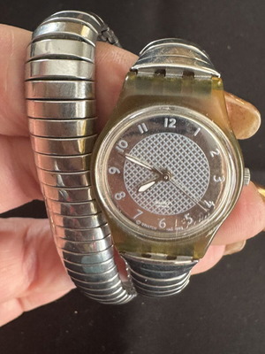Vintage Swatch wristwatch with transparent case and metal flex bracelet