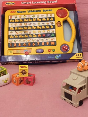 Educational toy set like new with learning board, dragon figure, animal cubes, and Nemo truck