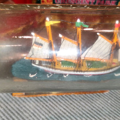 Ship in a bottle used with sealed top and wooden base