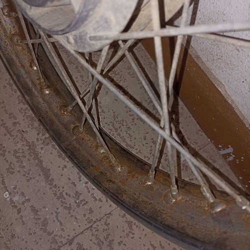 Motorcycle rim used, old with surface rust and missing spoke