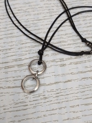 Men's black pendant with silver circles