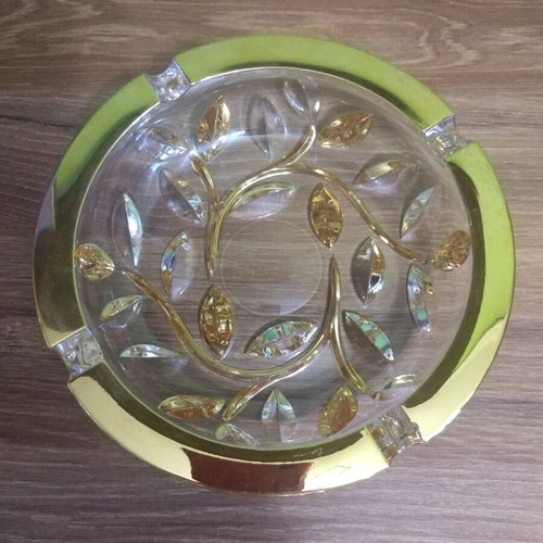 Crystal ashtray used, heavy with embossed gold-plated designs