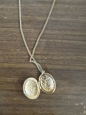 Vintage gold locket necklace used with embossed leaf design