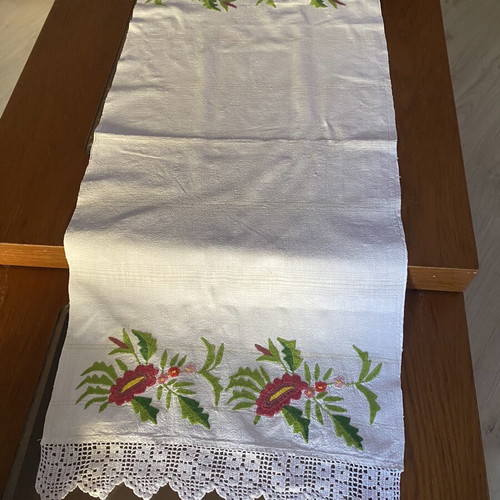 Handmade embroidered runner with red flowers and white crochet lace