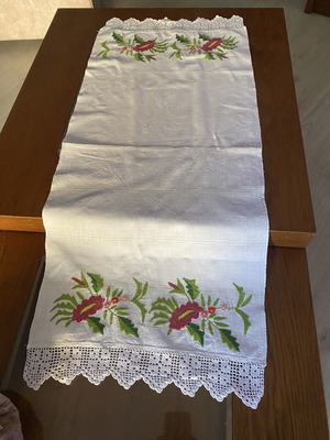 Handmade embroidered runner with red flowers and white crochet lace
