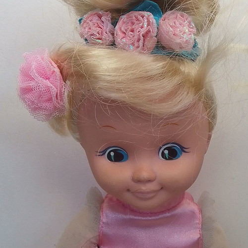 Vintage Uneeda doll with pink clothes, blond hair, blue eyes used