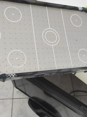 Air hockey board game new, battery operated with two handles and three paddles
