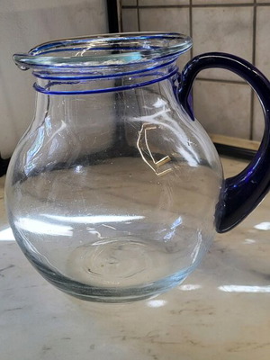 Glass pitcher with blue handle like new
