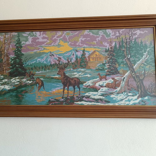 Handmade cross-stitch embroidery in wooden frame, used
