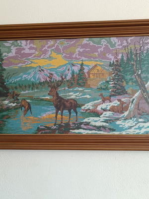 Handmade cross-stitch embroidery in wooden frame, used