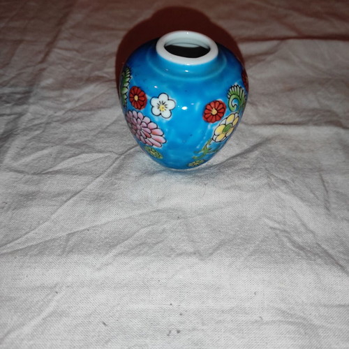Small blue vase with porcelain flowers used