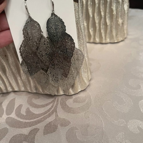 Silver dangling earrings with leaf design used