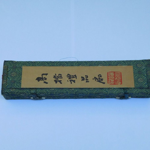 Traditional Chinese sandalwood fan with decorative tassel