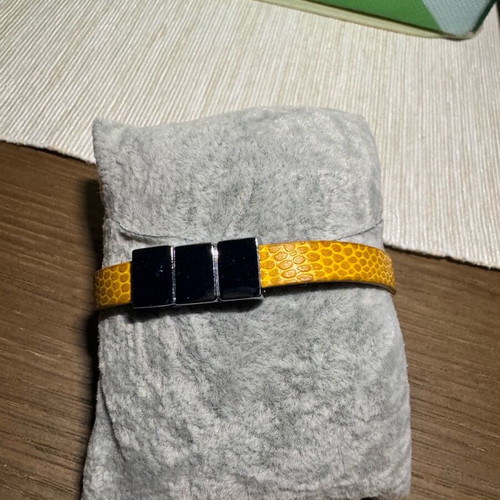 Bracelet with yellow leather strap like new with three metal charms